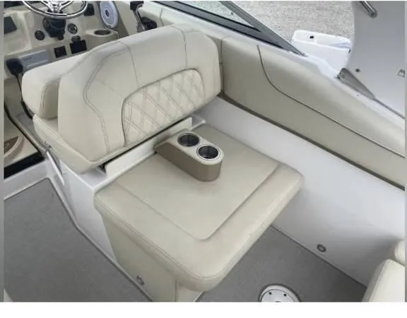 Slide: The Image of 2020 Regal 26 XO boat interior with beige seating and cup holders. - 23