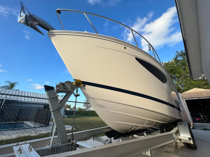 Slide: The Image of 2020 Regal 26 XO boat on trailer, clear sky background. - 3