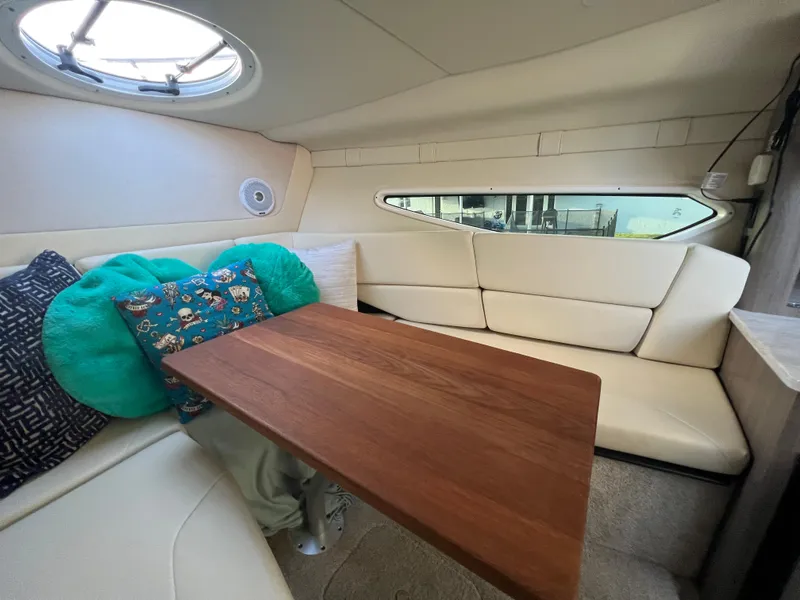 Slide: The Image of 2020 Regal 26 XO cabin interior with cozy seating and wooden table. - 30