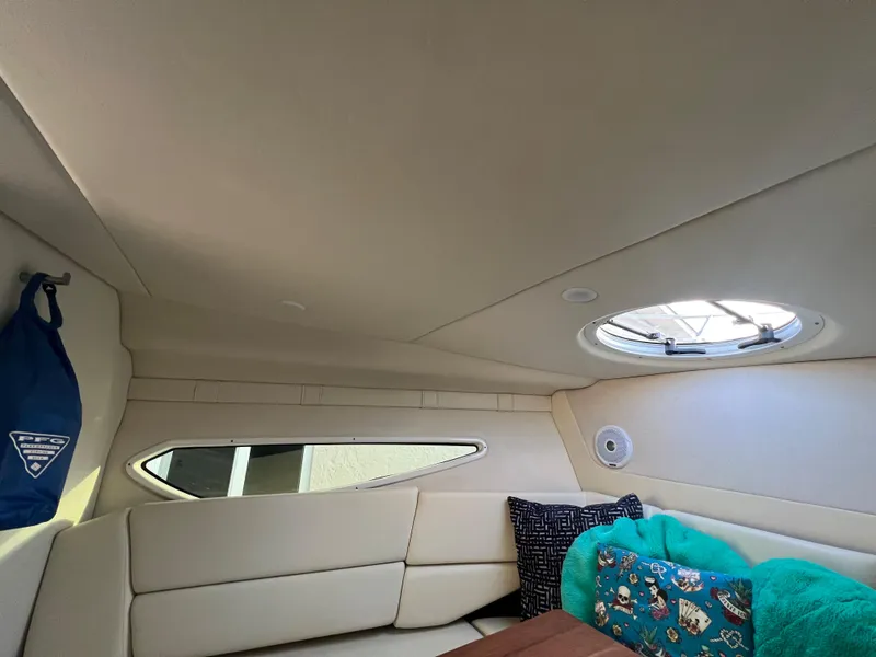 Slide: The Image of Interior of 2020 Regal 26 XO boat with cozy seating and porthole. - 33