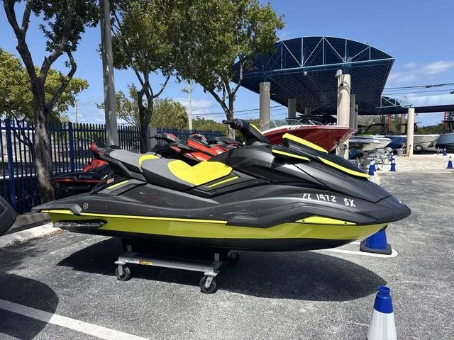 Slide: The Image of 2021 Yamaha WaveRunner FX SVHO jet ski in a parking lot, black and yellow design. - 3