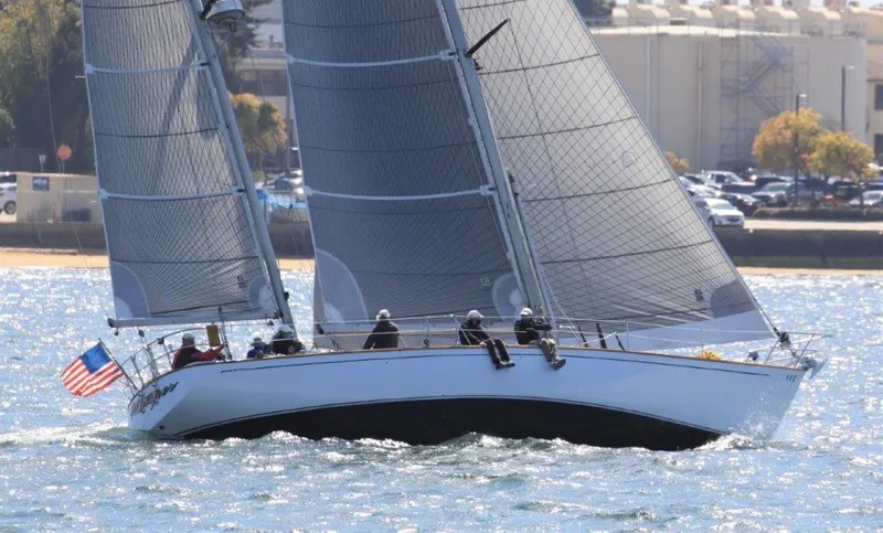 Slide: The Image of 1980 Skye 51 Ketch Kaufman & Ladd sailboat on water, American flag, sunny day. - 0