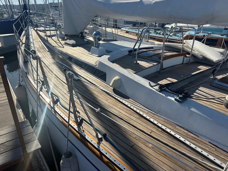 Slide: The Image of 1980 Skye 51 Ketch sailboat with wooden deck, docked in a marina. - 10