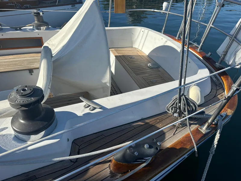 Slide: The Image of 1980 Skye 51 Ketch sailboat deck with ropes and winch in marina. - 11