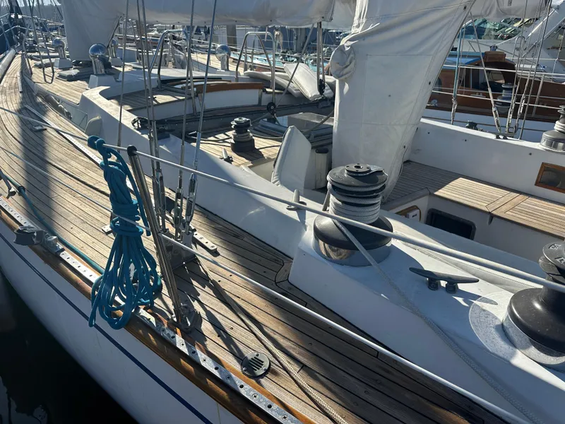 Slide: The Image of 1980 Skye 51 Ketch sailboat deck with rigging and winches in marina. - 12