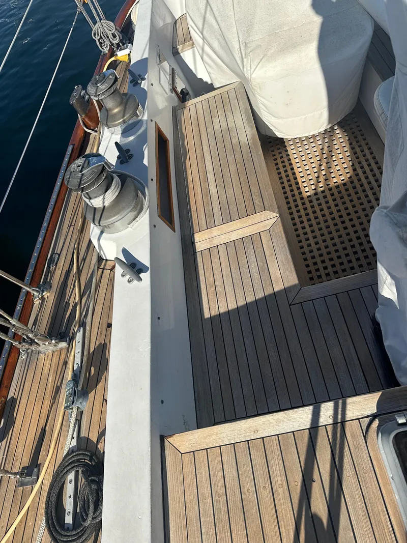 Slide: The Image of 1980 Skye 51 Ketch sailboat deck with wooden seating and winches. - 15