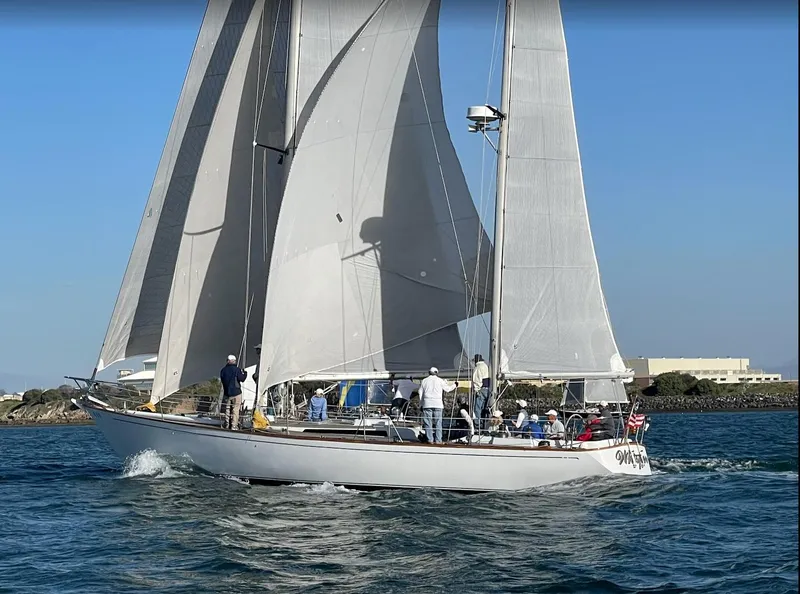 Slide: The Image of 1980 Skye 51 Ketch Kaufman & Ladd sailboat on open water, full sails, clear sky. - 2