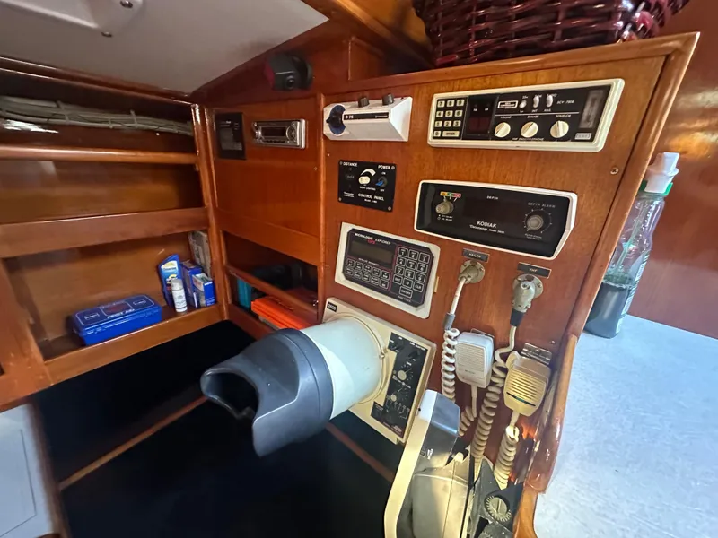 Slide: The Image of 1980 Skye 51 Ketch sailboat interior with navigation equipment and wooden cabinetry. - 22