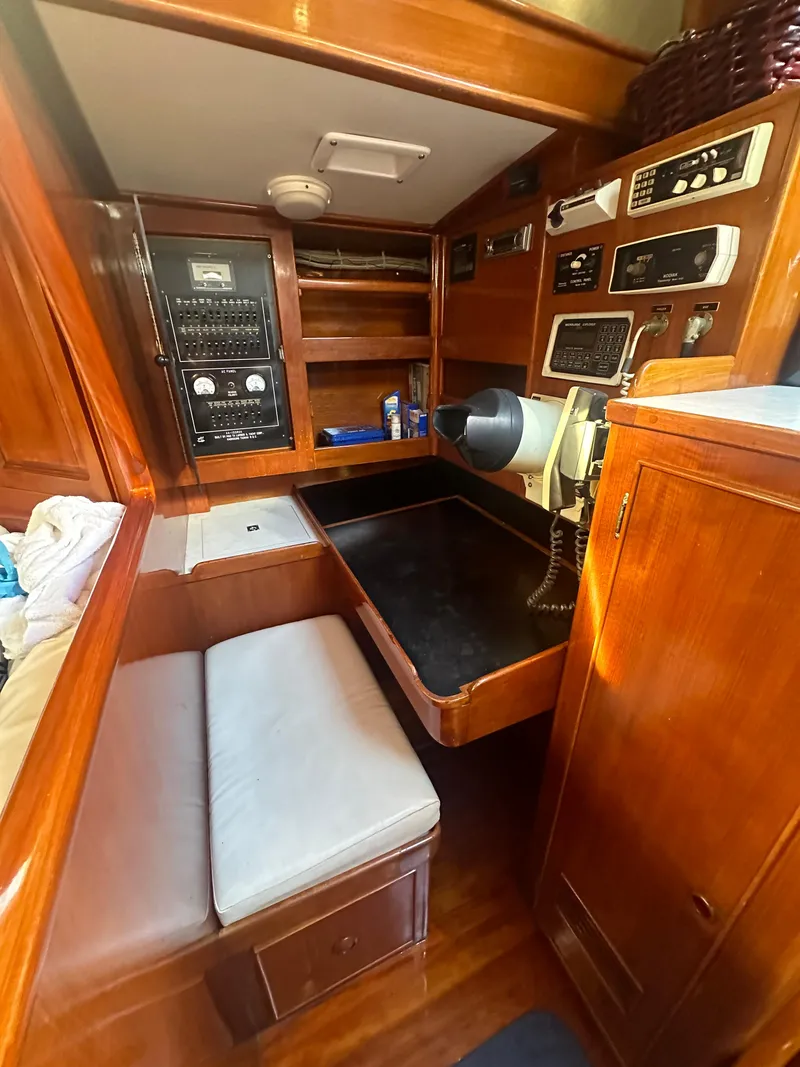 Slide: The Image of 1980 Skye 51 Ketch sailboat interior with navigation station and wooden cabinetry. - 23