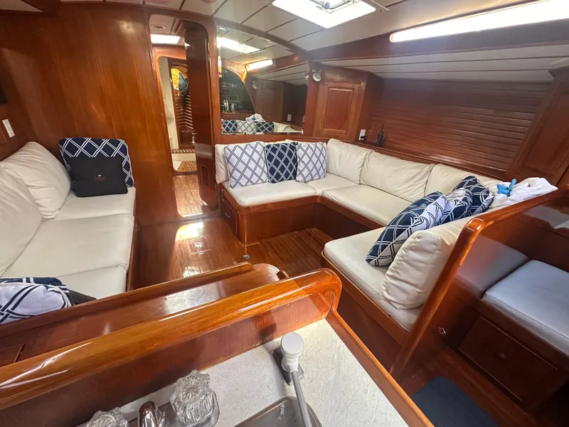 Slide: The Image of Interior of 1980 Skye 51 Ketch sailboat with cozy seating and wooden finishes. - 24