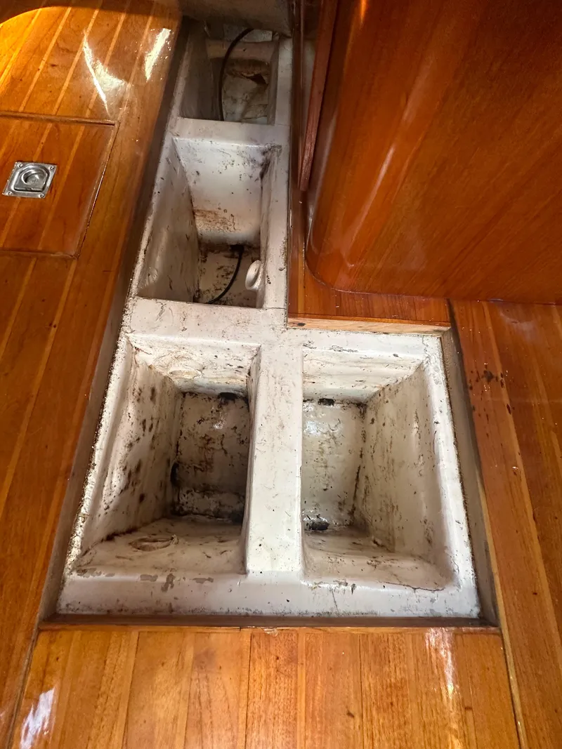 Slide: The Image of Interior view of 1980 Skye 51 Ketch sailboat with wooden flooring and storage compartments. - 28
