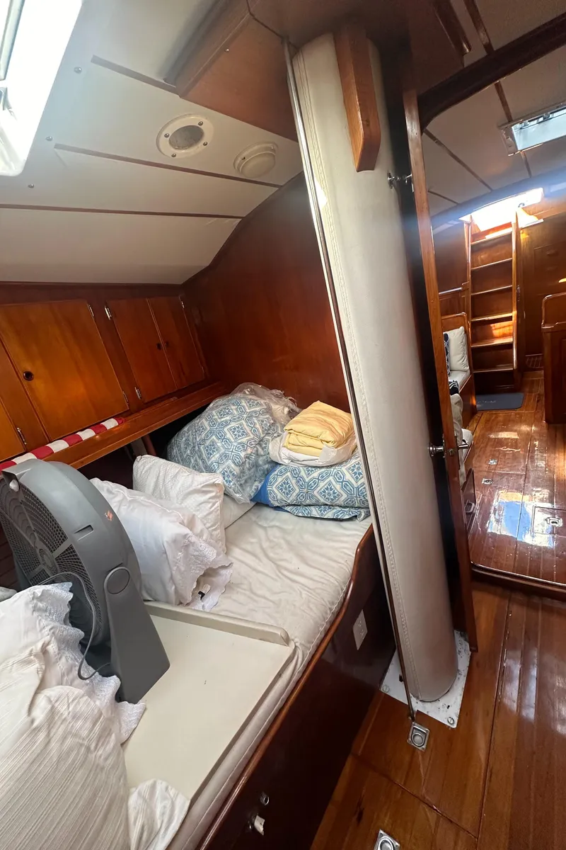 Slide: The Image of Cozy cabin interior of 1980 Skye 51 Ketch sailboat with wooden finishes and bedding. - 29