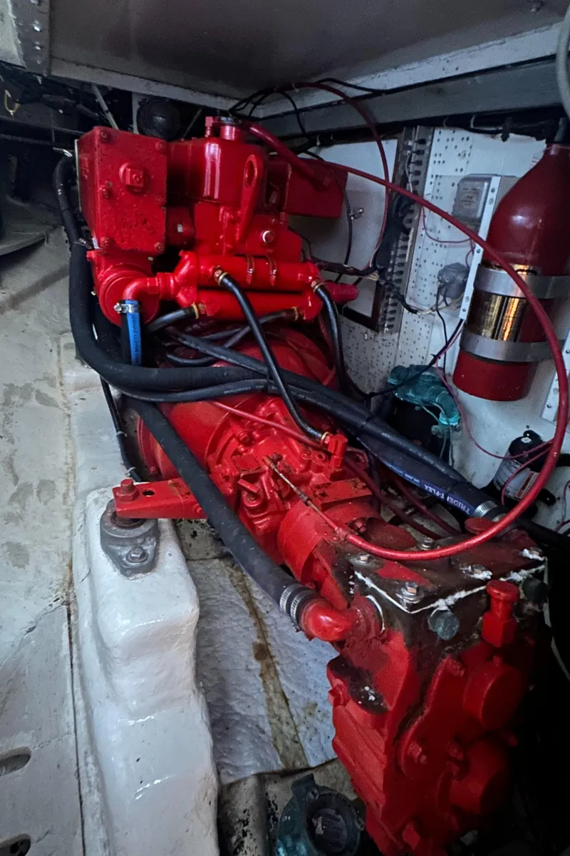 Slide: The Image of Engine compartment of 1980 Skye 51 Ketch sailboat, featuring red machinery and wiring. - 31