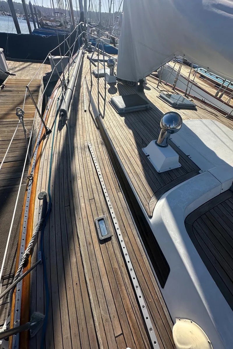 Slide: The Image of 1980 Skye 51 Ketch sailboat deck with wooden finish and rigging details. - 37