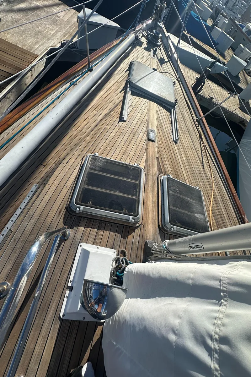 Slide: The Image of 1980 Skye 51 Ketch sailboat deck with wooden finish and hatches. - 38