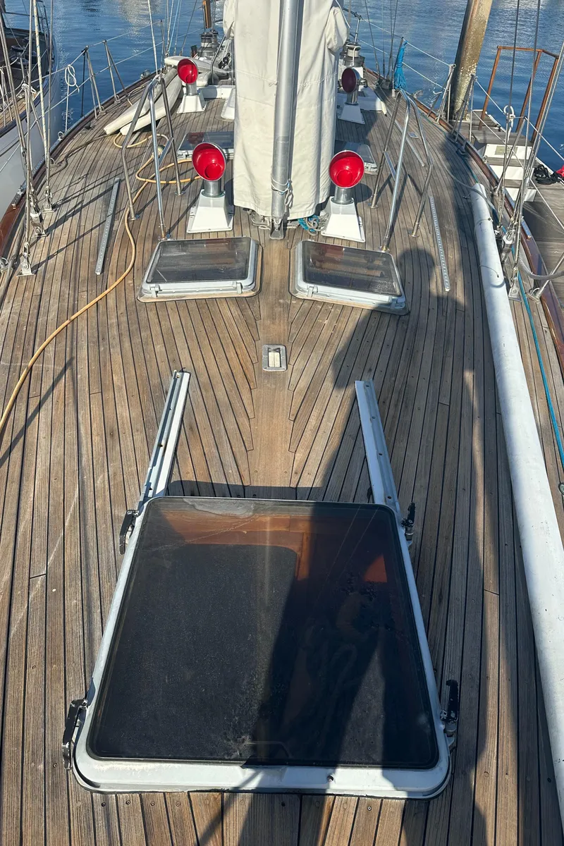 Slide: The Image of 1980 Skye 51 Ketch sailboat deck with wooden finish and open hatches. - 40