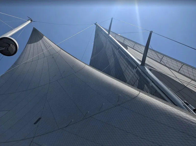 Slide: The Image of Sails of a 1980 Skye 51 Ketch Kaufman & Ladd sailboat against a clear blue sky. - 44