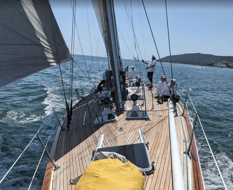 Slide: The Image of 1980 Skye 51 Ketch sailboat cruising with crew on deck, open sea background. - 46