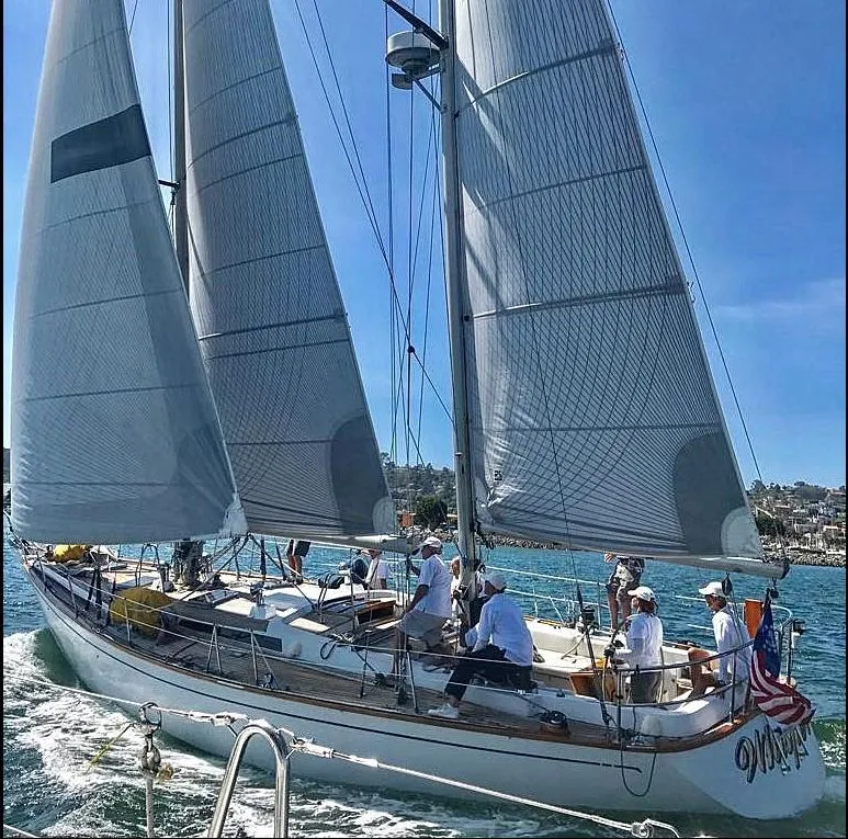 Slide: The Image of 1980 Skye 51 Ketch sailboat on water, crew onboard, sunny day. - 49
