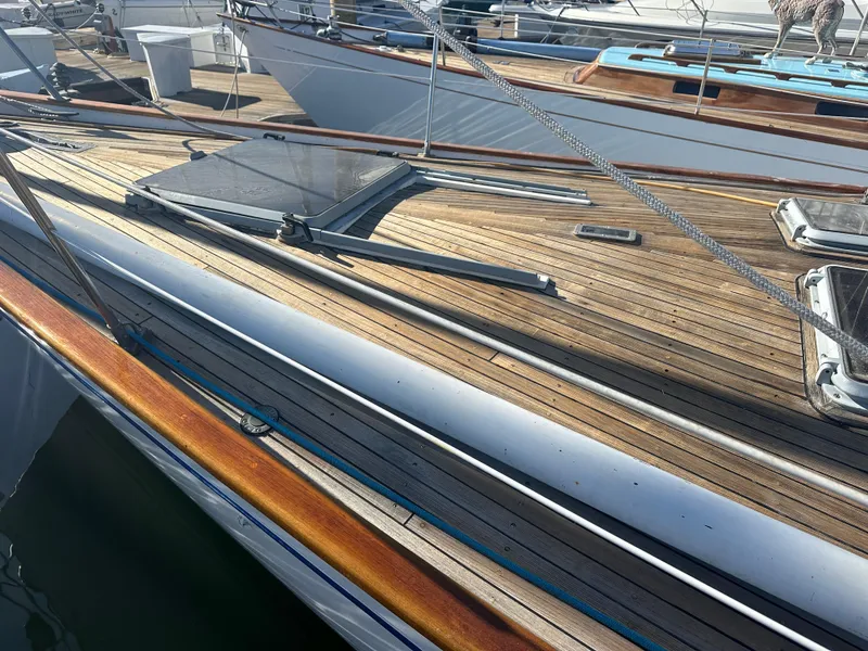 Slide: The Image of 1980 Skye 51 Ketch sailboat deck with wooden finish and rigging details. - 7