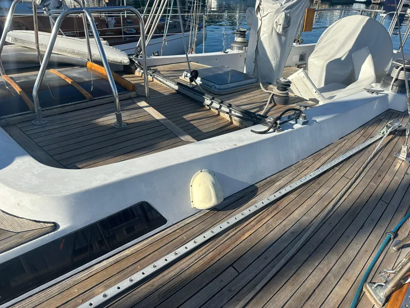 Slide: The Image of 1980 Skye 51 Ketch sailboat deck with wooden finish and nautical equipment. - 8