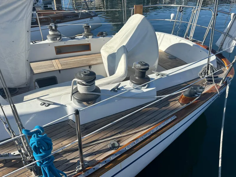 Slide: The Image of 1980 Skye 51 Ketch sailboat deck with winches and ropes in a marina. - 9