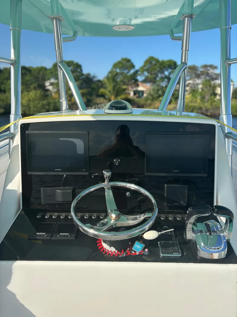 Slide: The Image of 2006 Buddy Davis 34 Center Console helm with modern controls and dual screens. - 12