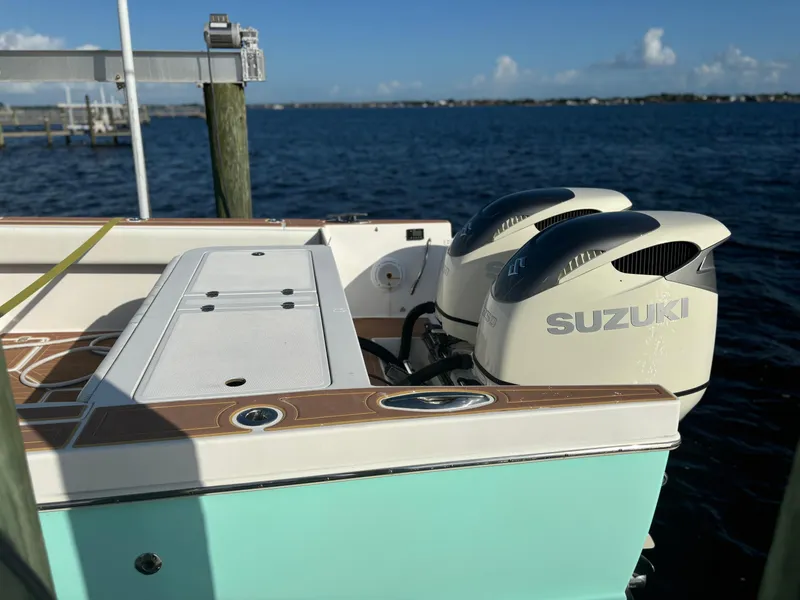 Slide: The Image of 2006 Buddy Davis 34 Center Console with Suzuki outboard motors on a sunny day. - 16