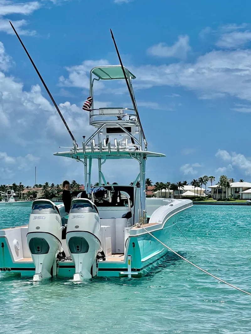 Slide: The Image of 2006 Buddy Davis 34 Center Console boat on turquoise water, clear sky background. - 2