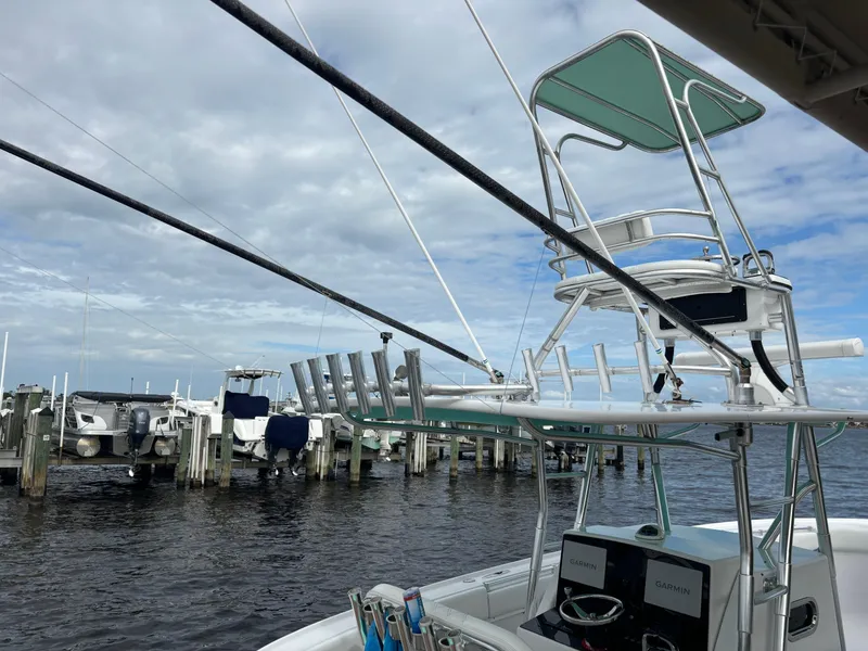 Slide: The Image of 2006 Buddy Davis 34 Center Console boat docked at marina under cloudy sky. - 7