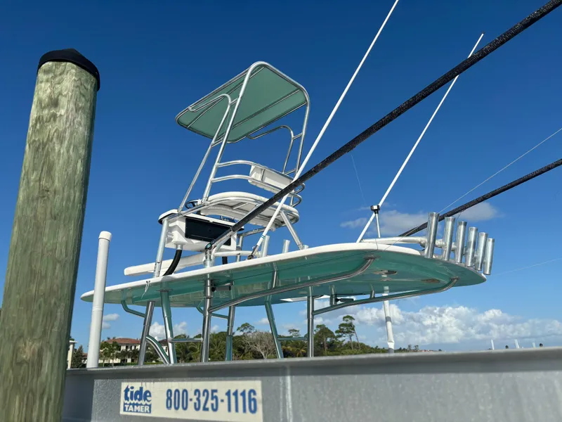 Slide: The Image of 2006 Buddy Davis 34 Center Console boat docked under clear blue sky. - 8