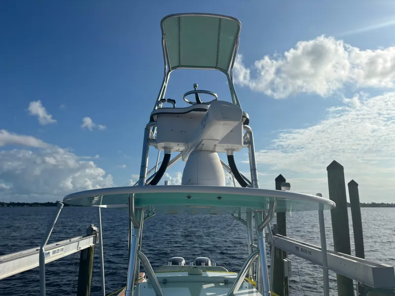 Slide: The Image of 2006 Buddy Davis 34 Center Console boat docked by the water under a clear sky. - 9