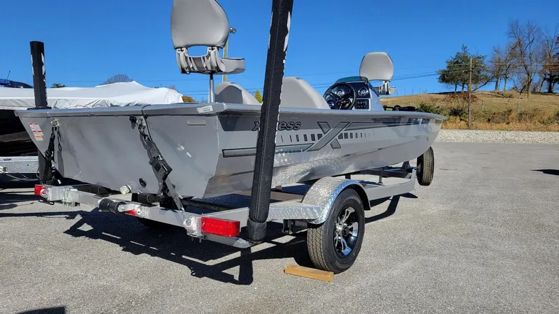 Slide: The Image of 2025 Xpress XP180 Bass boat with Yamaha F25 hp engine on trailer. - 2