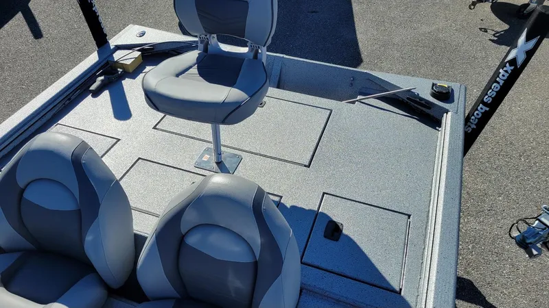 Slide: The Image of 2025 Xpress XP180 Bass boat interior with seating and storage compartments. - 8