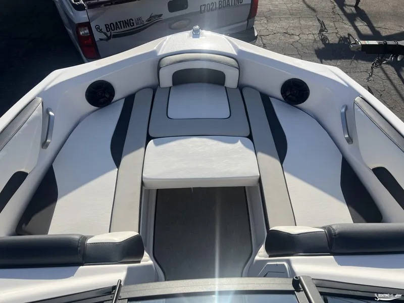 Slide: The Image of 2024 Yamaha AR195 boat interior with white and black seating, speakers, and sleek design. - 5