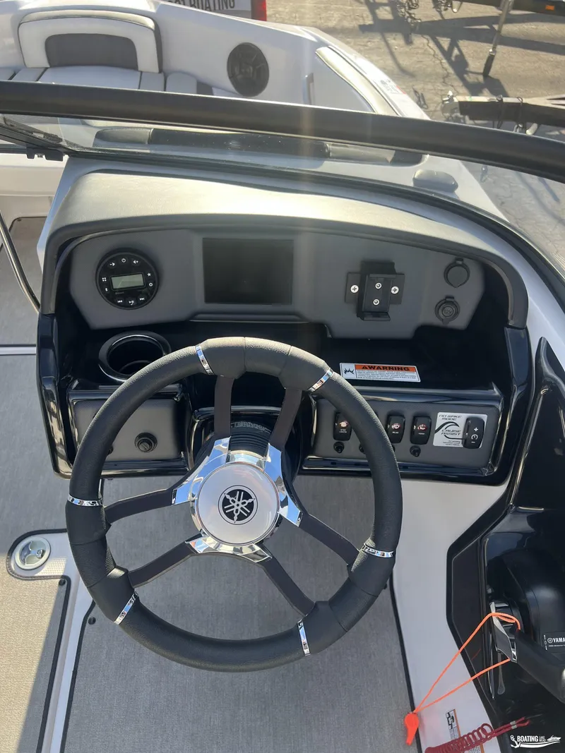 Slide: The Image of 2024 Yamaha AR195 boat dashboard with steering wheel and control panel. - 9