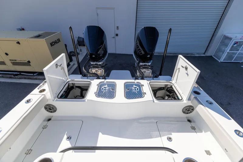 Slide: The Image of 2024 Freeman 28 boat with dual engines and open storage compartments. - 13