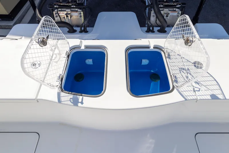 Slide: The Image of Freeman 28 boat, 2024 model, featuring dual open livewells with blue interiors. - 18