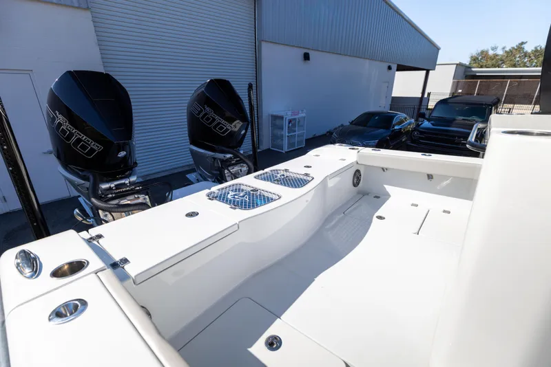 Slide: The Image of 2024 Freeman 28 boat with dual outboard motors in a marina setting. - 21