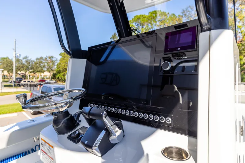Slide: The Image of 2024 Freeman 28 boat dashboard with steering wheel and control panel. - 24