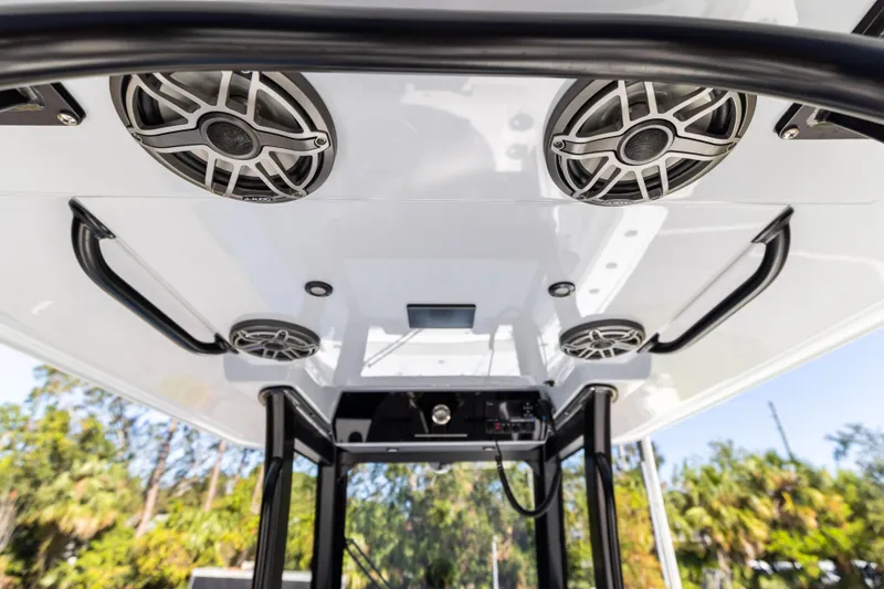 Slide: The Image of 2024 Freeman 28 boat speakers and canopy, outdoor setting. - 25