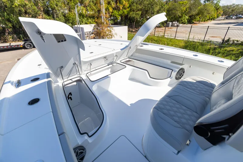Slide: The Image of 2024 Freeman 28 boat with open storage compartments and cushioned seating. - 38