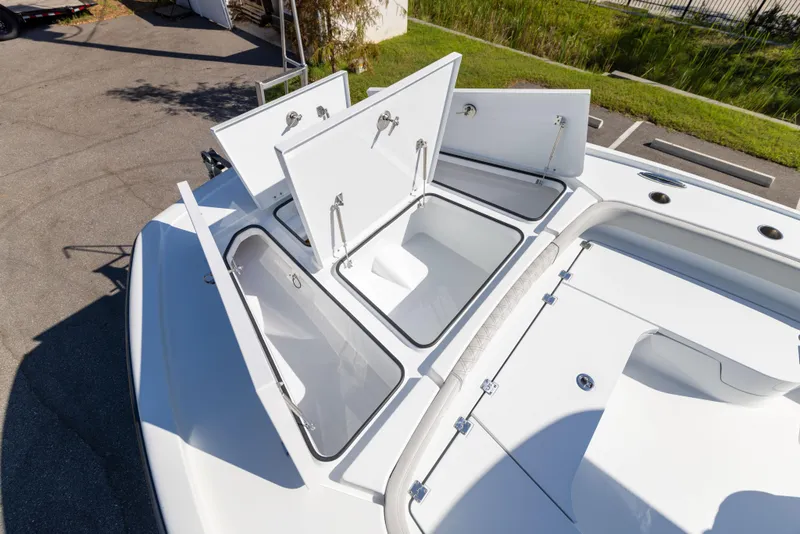 Slide: The Image of 2024 Freeman 28 boat with open storage compartments on deck. - 39