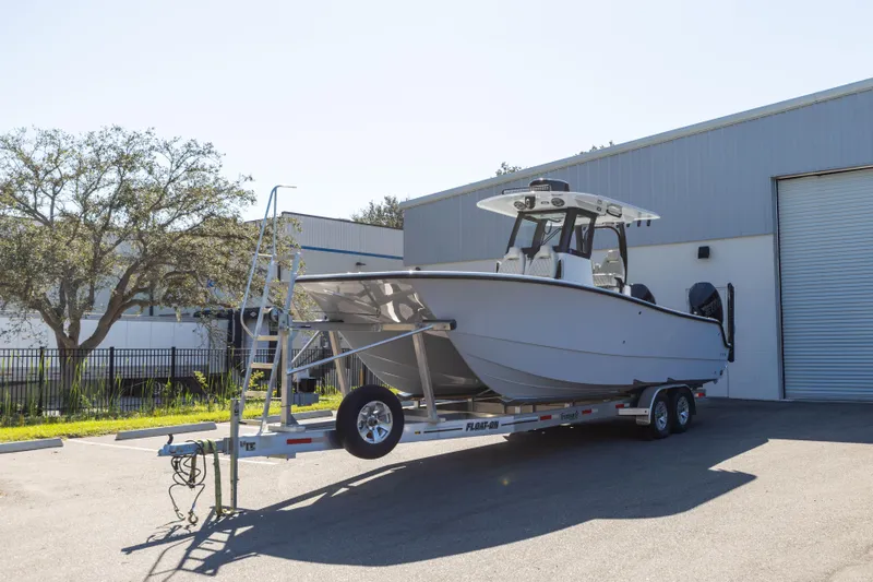 Slide: The Image of 2024 Freeman 28 boat on trailer outside industrial building. - 5