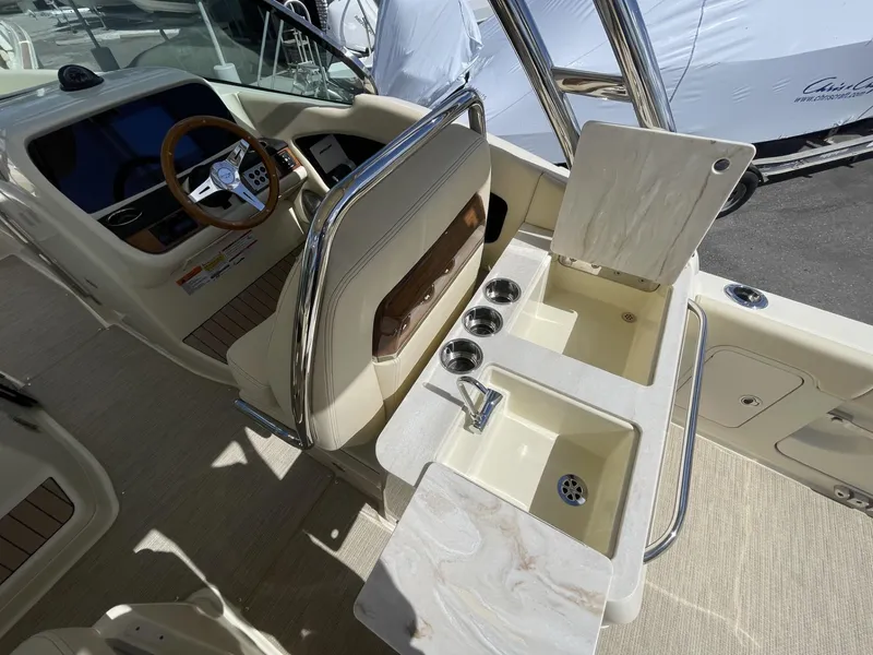 Slide: The Image of 2025 Chris-Craft Calypso 28 boat interior with sink and steering wheel. - 10