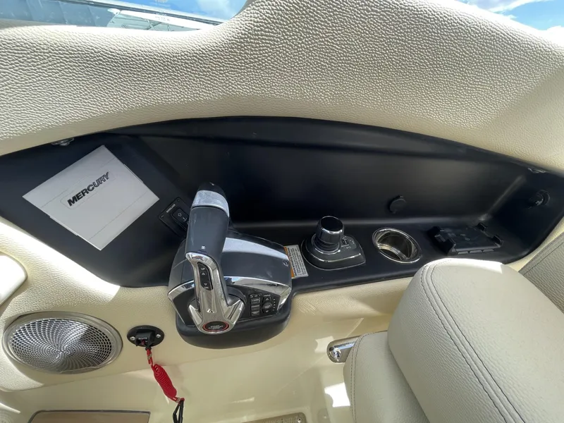 Slide: The Image of 2025 Chris-Craft Calypso 28 boat cockpit with Mercury controls and beige interior. - 11