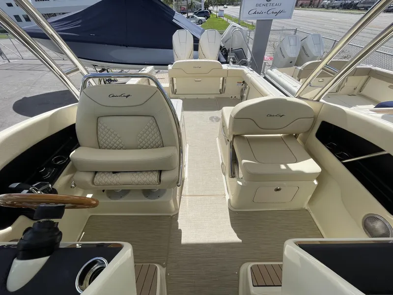Slide: The Image of 2025 Chris-Craft Calypso 28 boat interior with beige seating and helm. - 14