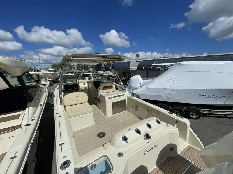 Slide: The Image of 2025 Chris-Craft Calypso 28 boat with spacious deck under a clear blue sky. - 3