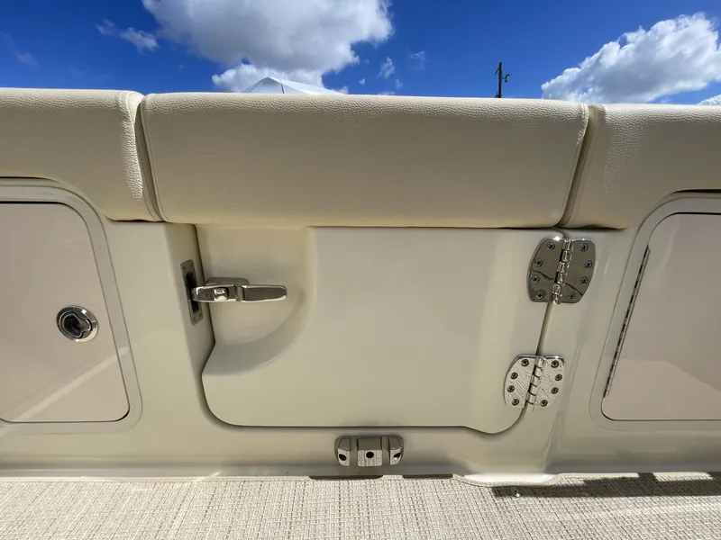 Slide: The Image of 2025 Chris-Craft Calypso 28 boat interior detail with storage compartments and latch. - 7