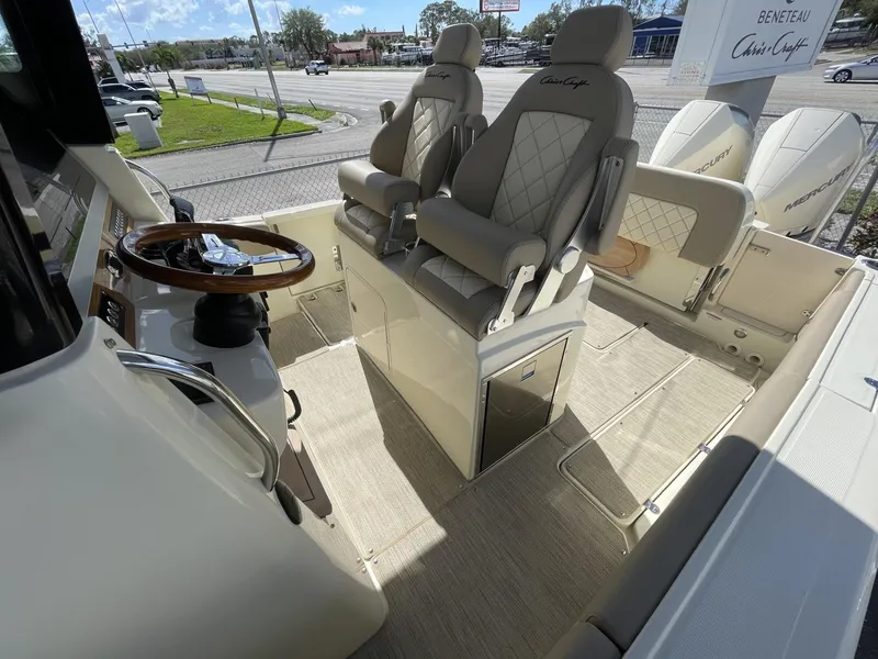 Slide: The Image of 2025 Chris-Craft Catalina 30 boat interior with luxury seating and steering wheel. - 10